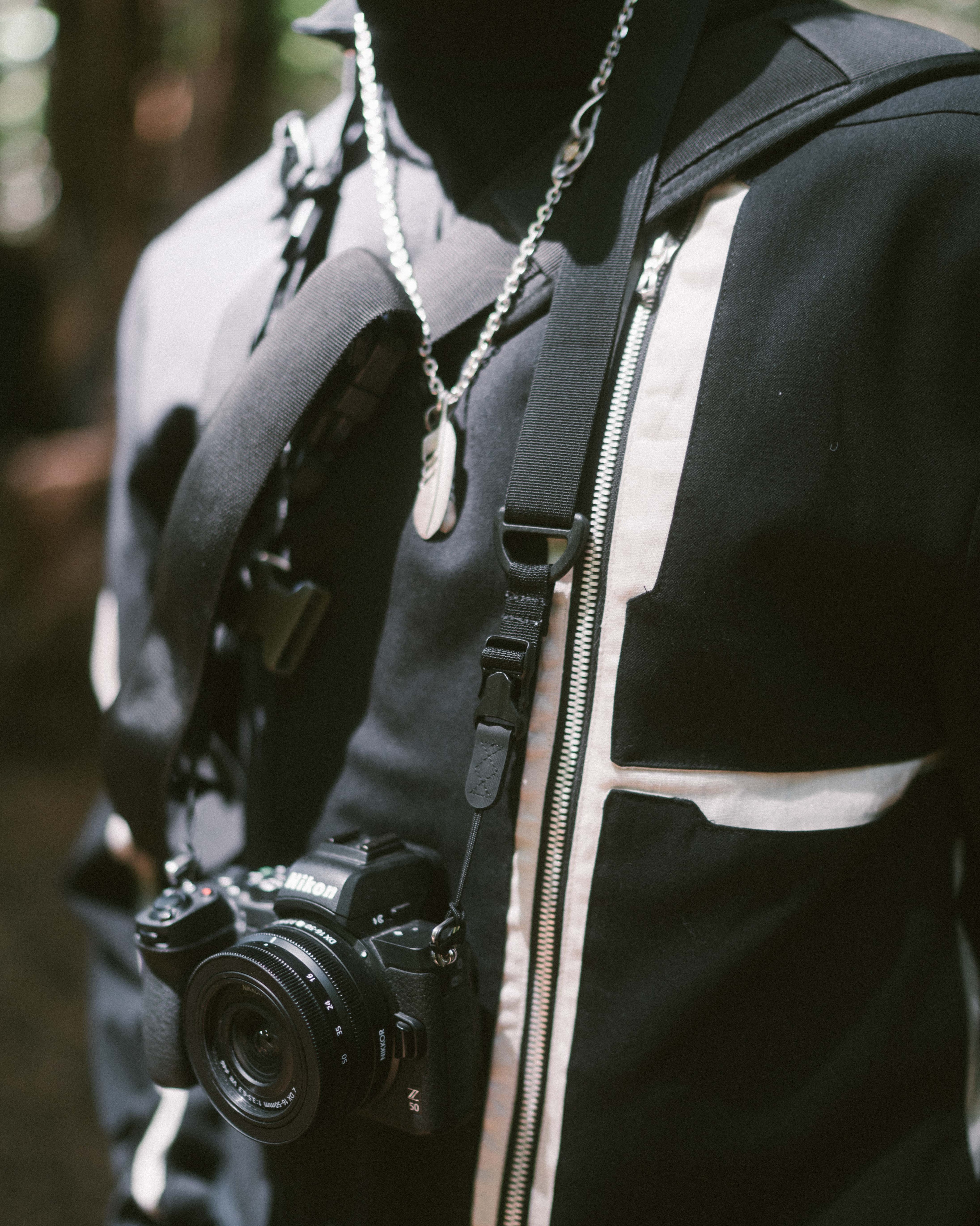 A closeup of Matt's camera, showing the details on his jacket, and eagle-feather necklace.