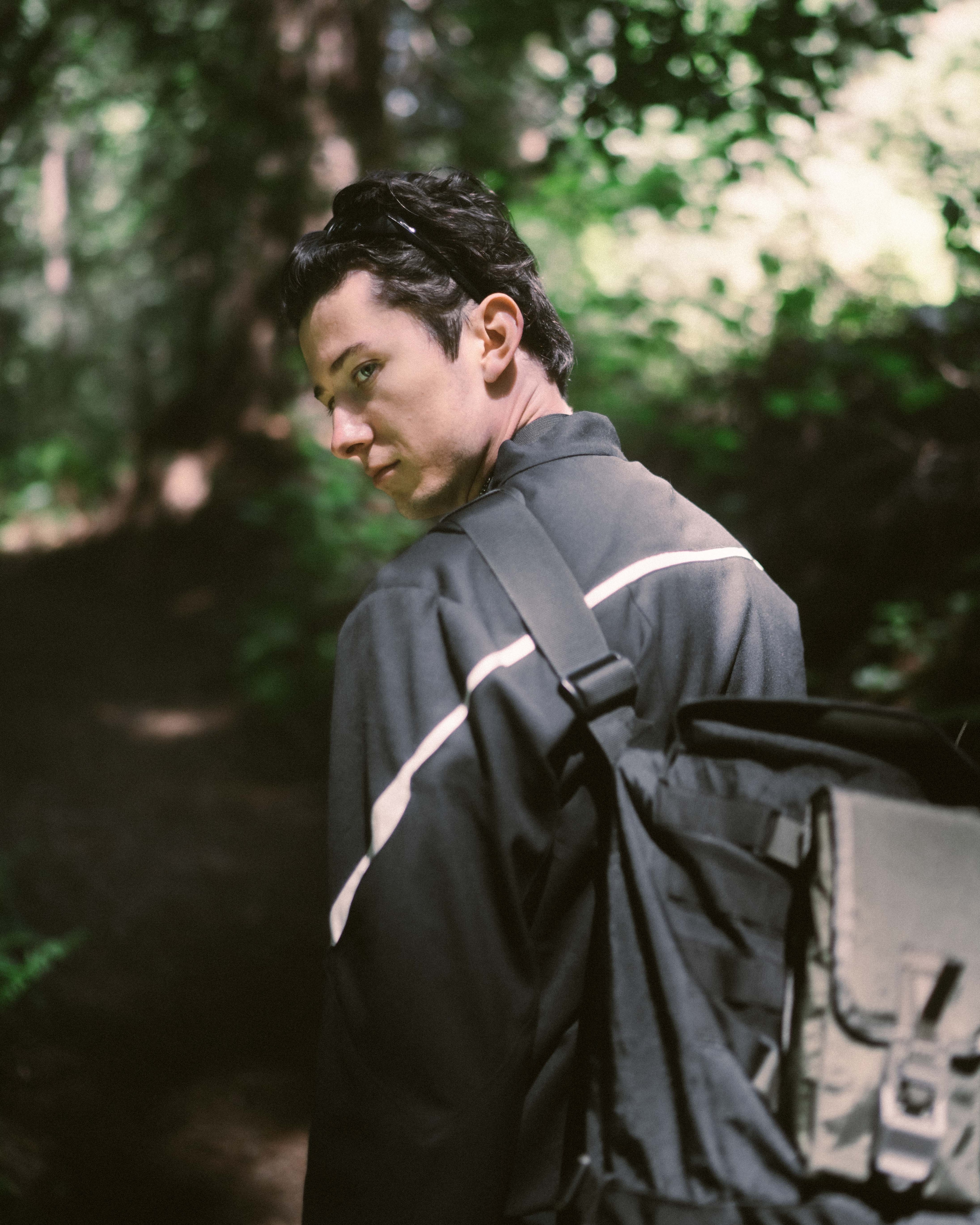 An over-the-shoulder photo of Matt, showing the details on the back of his jacket and bag.