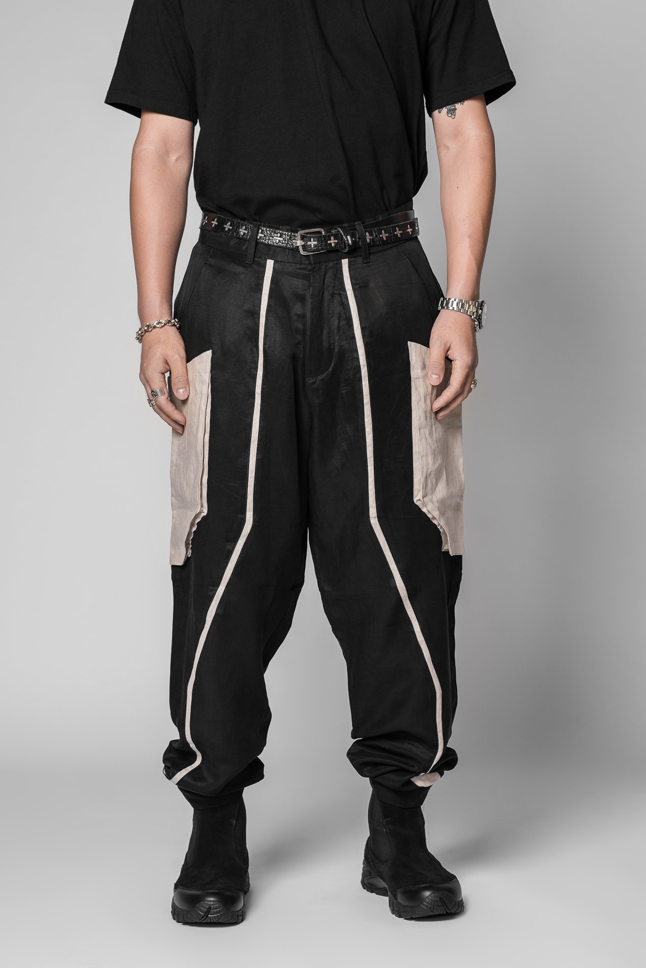 Product shot of a model wearing the black and sand Autograft Cargo Pants
